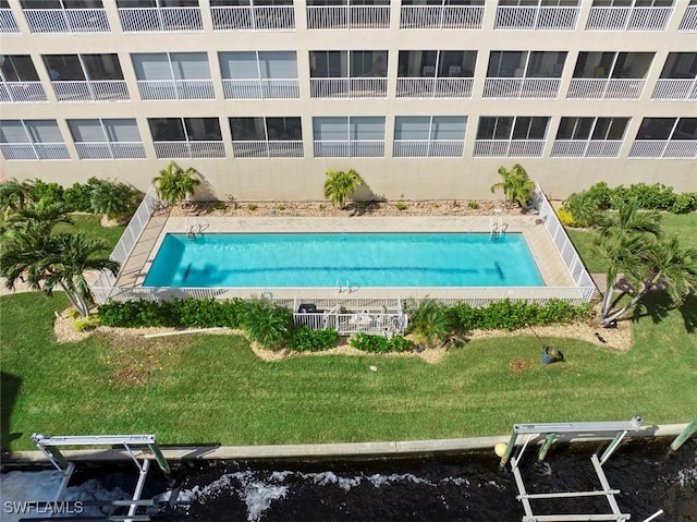 view of pool with a lawn