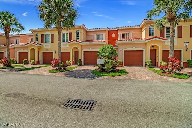 mediterranean / spanish-style house with a garage