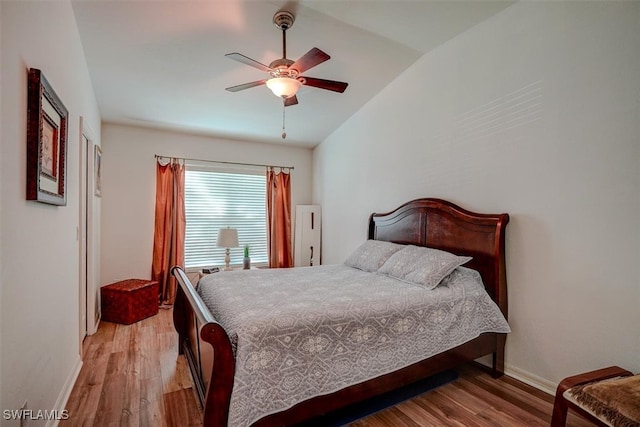 bedroom featuring light wood-type flooring, lofted ceiling, and ceiling fan