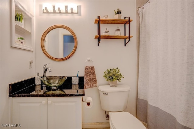 bathroom with a shower with shower curtain, vanity, and toilet