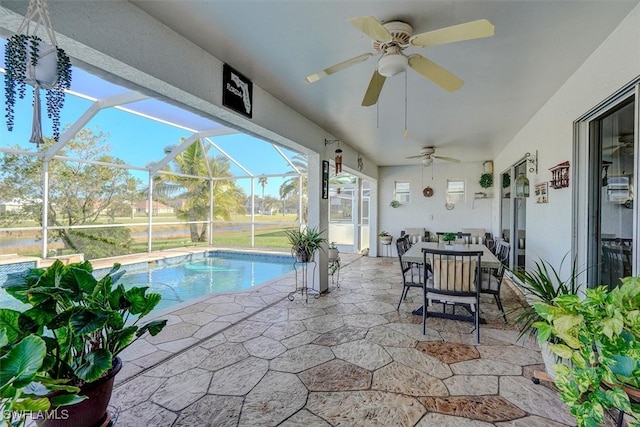 view of swimming pool featuring glass enclosure, a patio, and ceiling fan