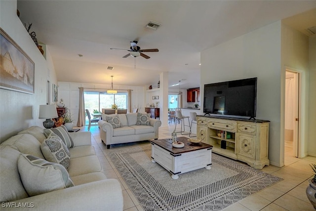 tiled living room with ceiling fan