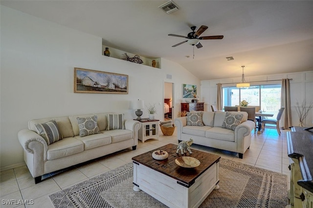 tiled living room featuring ceiling fan and vaulted ceiling