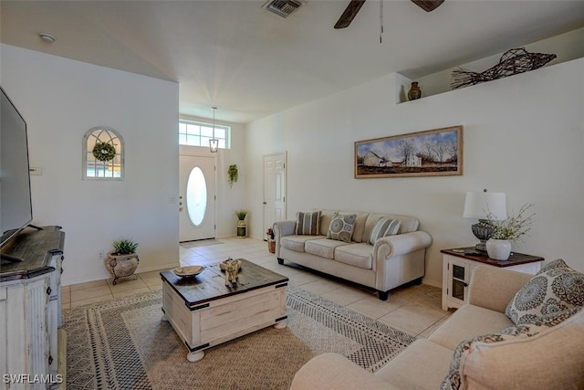 living room featuring light tile patterned floors and ceiling fan