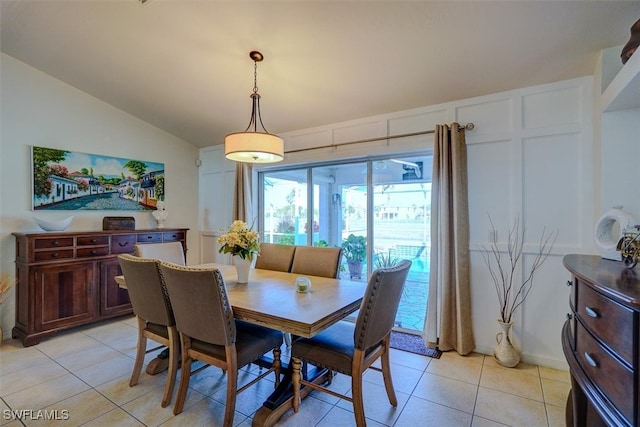 tiled dining space with lofted ceiling