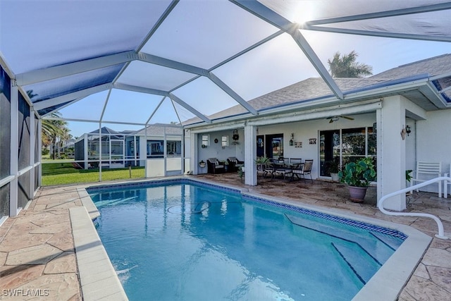 view of swimming pool with a patio area, a lanai, and ceiling fan