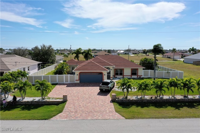 view of front of property featuring a garage and a front yard