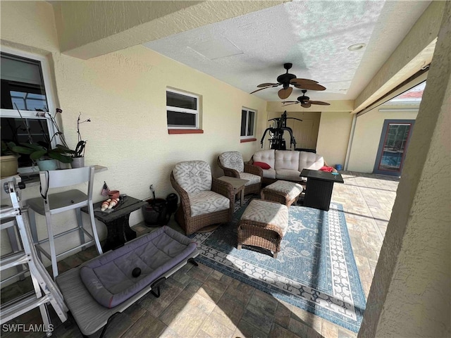 view of patio with ceiling fan and an outdoor hangout area