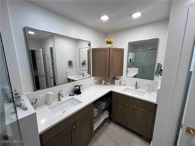 bathroom featuring vanity and a shower with door