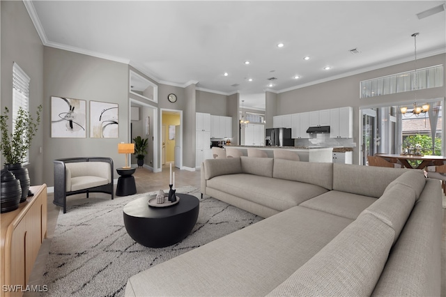 living room featuring a chandelier and crown molding