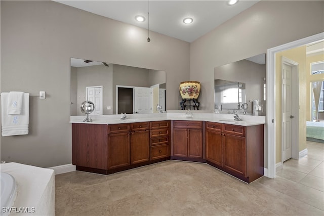 bathroom featuring vanity, plenty of natural light, and a bathtub