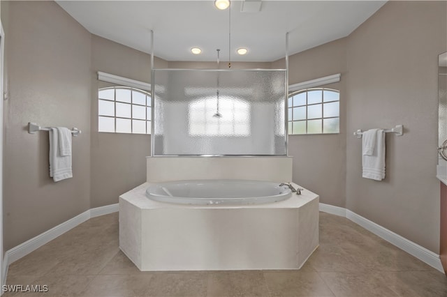 bathroom with tile patterned flooring, plenty of natural light, and independent shower and bath