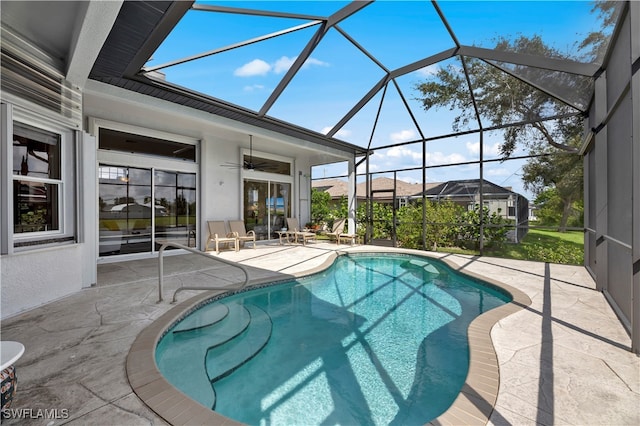 view of pool with ceiling fan, a patio, and a lanai