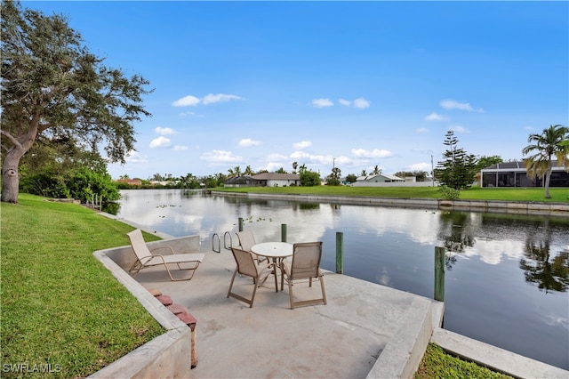 view of patio with a water view and glass enclosure