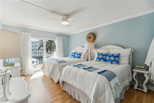 bedroom with access to exterior, ornamental molding, a textured ceiling, ceiling fan, and hardwood / wood-style floors