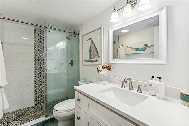 bathroom featuring vanity, toilet, and an enclosed shower