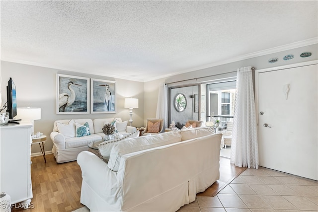 living room with light tile patterned floors, a textured ceiling, and ornamental molding