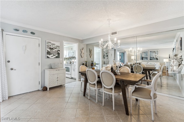 dining room with crown molding, light tile patterned floors, a textured ceiling, and a notable chandelier