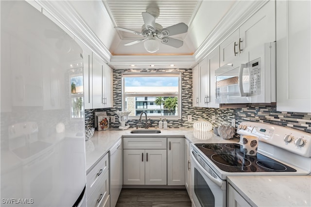 kitchen featuring white cabinets, white appliances, ornamental molding, and sink