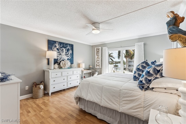 bedroom with ceiling fan, light wood-type flooring, and a textured ceiling