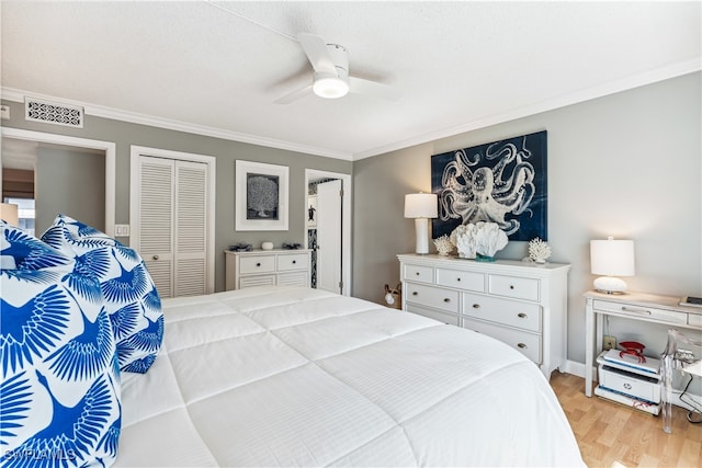 bedroom with a closet, light hardwood / wood-style flooring, ceiling fan, and ornamental molding