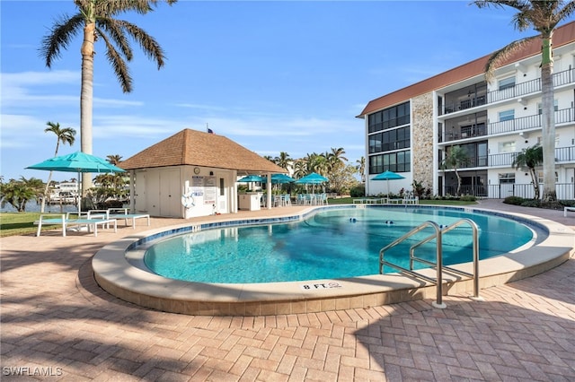 view of pool with a patio area and an outdoor structure