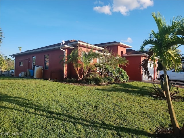 view of side of property with a lawn