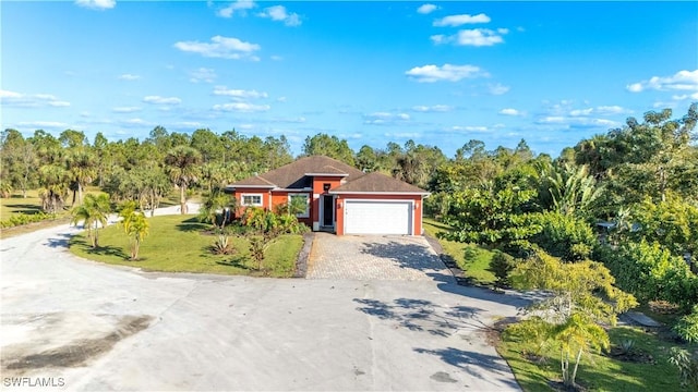 view of front of home with a front lawn and a garage