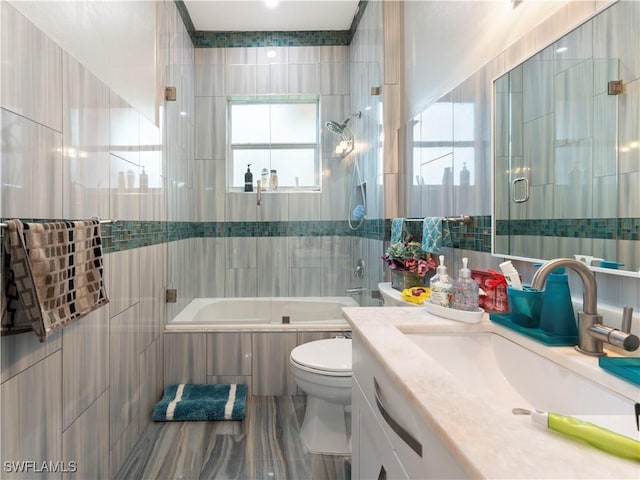 full bathroom featuring vanity, tile walls, and a wealth of natural light