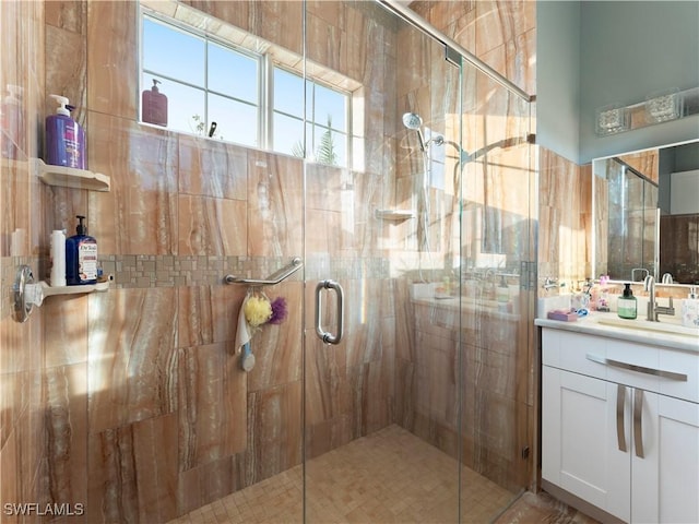 bathroom with vanity and a shower with shower door