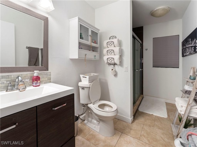 bathroom with vanity, tasteful backsplash, toilet, and walk in shower