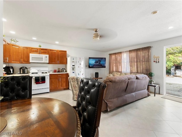 tiled living room featuring ceiling fan