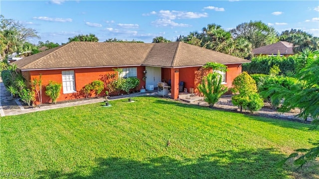 ranch-style home with a front lawn