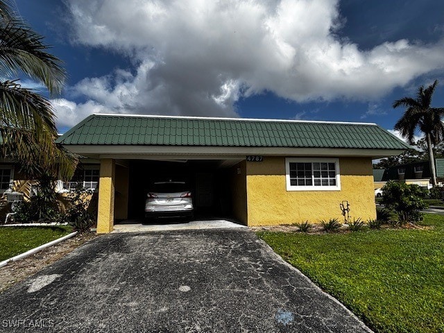 view of front facade featuring a front yard and a carport