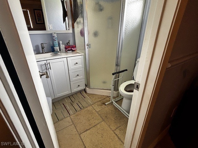 bathroom with vanity and a shower with door