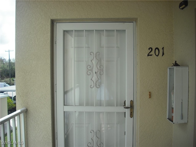 entrance to property featuring a balcony