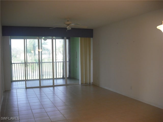 empty room featuring light tile patterned floors and ceiling fan