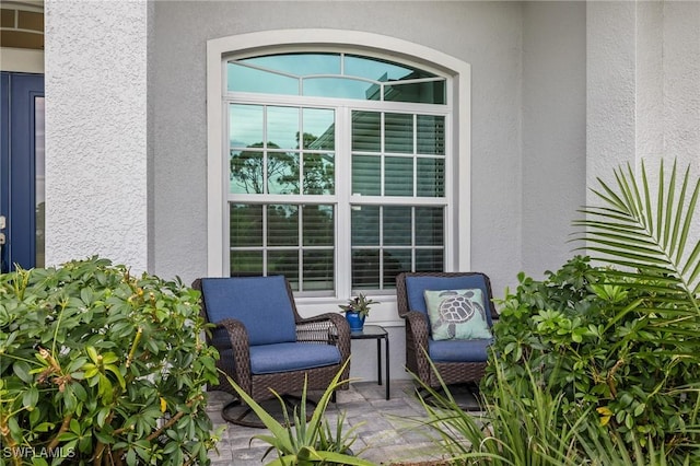 view of exterior entry with a patio area