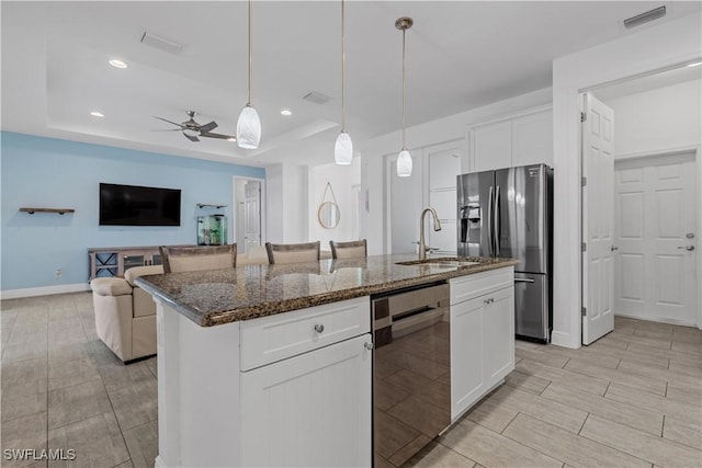 kitchen featuring white cabinetry, sink, a kitchen island with sink, and stainless steel refrigerator with ice dispenser