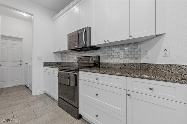 kitchen featuring white cabinetry, backsplash, black electric range, and dark stone counters