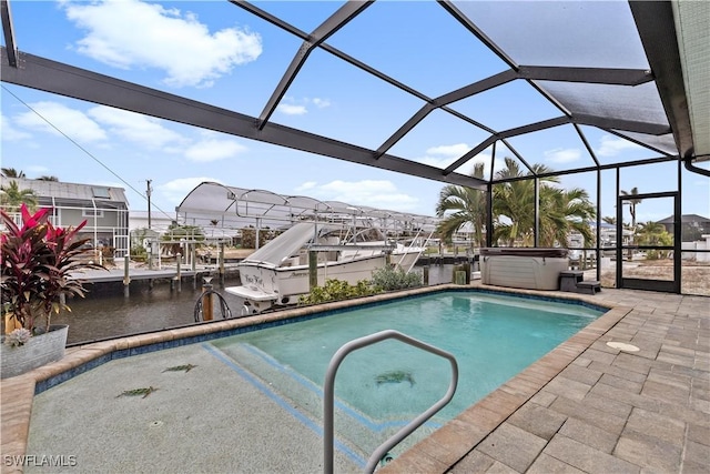 view of pool with a patio, a hot tub, a water view, and glass enclosure