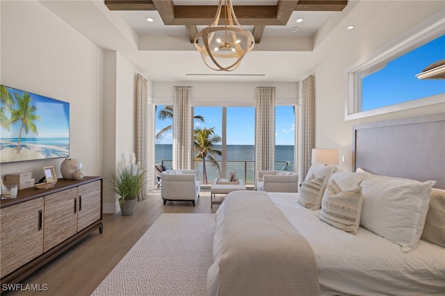 bedroom with hardwood / wood-style flooring, a chandelier, a water view, coffered ceiling, and beamed ceiling