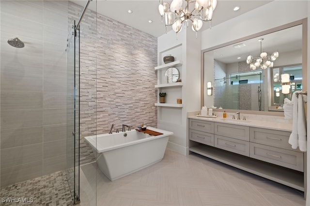 bathroom featuring an inviting chandelier, vanity, and independent shower and bath