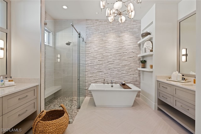 bathroom with vanity, plus walk in shower, and an inviting chandelier