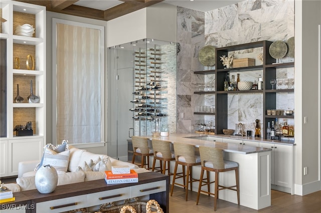 interior space featuring bar area, dark hardwood / wood-style flooring, and built in shelves