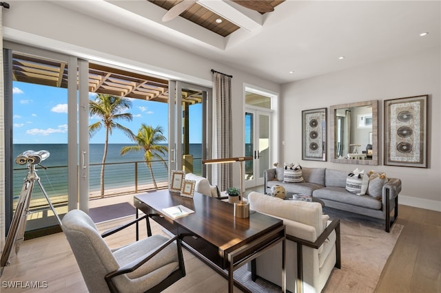 living room with a water view and light hardwood / wood-style floors