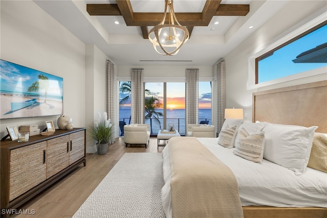 bedroom with a chandelier and light hardwood / wood-style floors