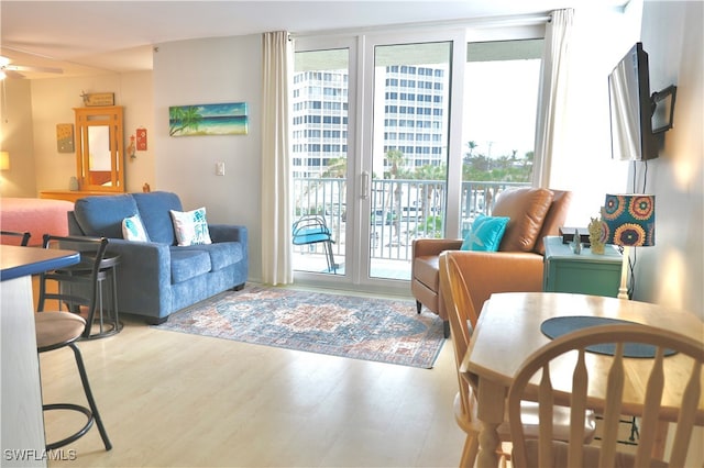 living room with ceiling fan and light wood-type flooring