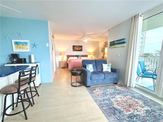 bedroom featuring access to exterior, ceiling fan, and light hardwood / wood-style floors