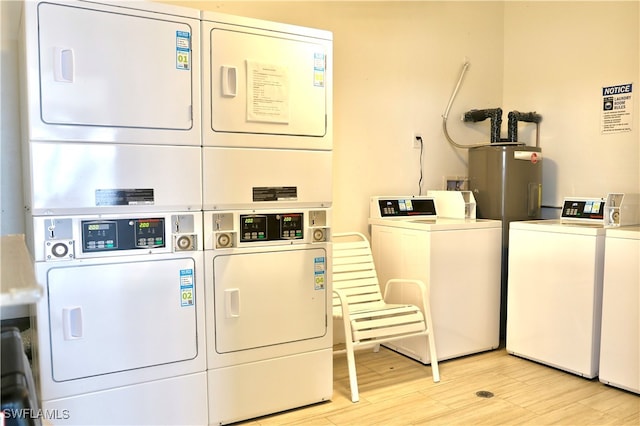 washroom with independent washer and dryer, light hardwood / wood-style flooring, and stacked washer / dryer